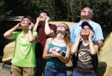 Family watching solar eclipse